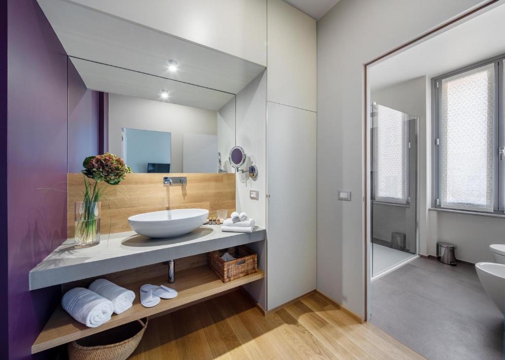 a bathroom with a sink and a mirror at 30Cavour luxury suites in Pavia