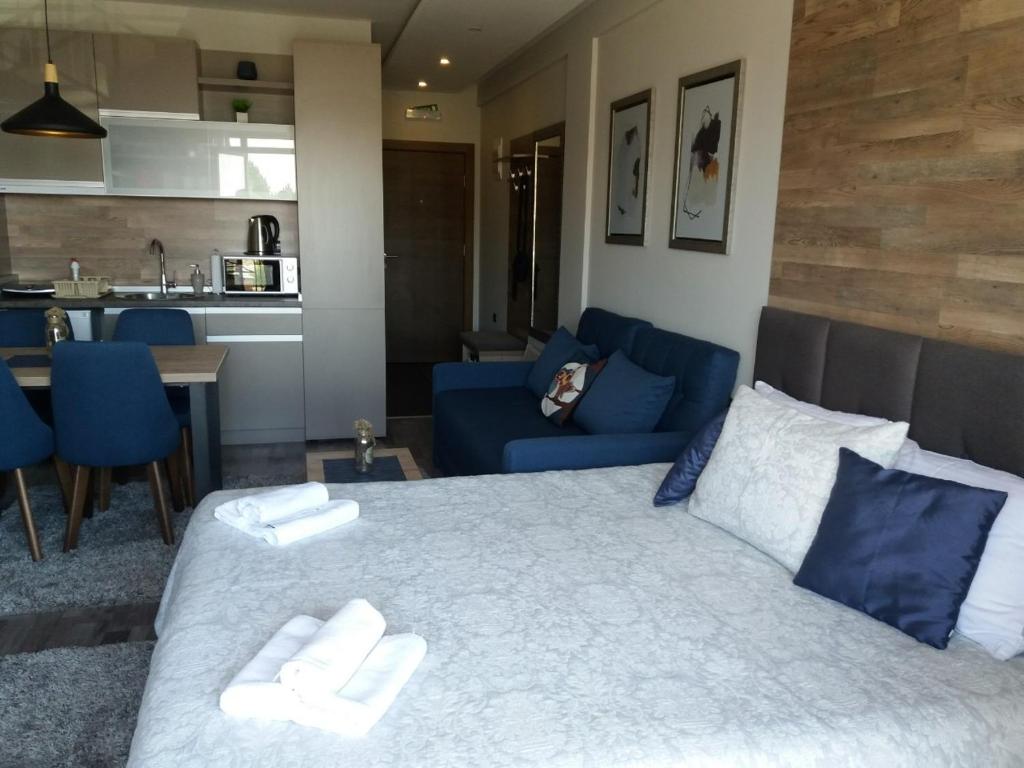 a bedroom with a large bed with two towels on it at MISS Premier 19 Milmari in Kopaonik