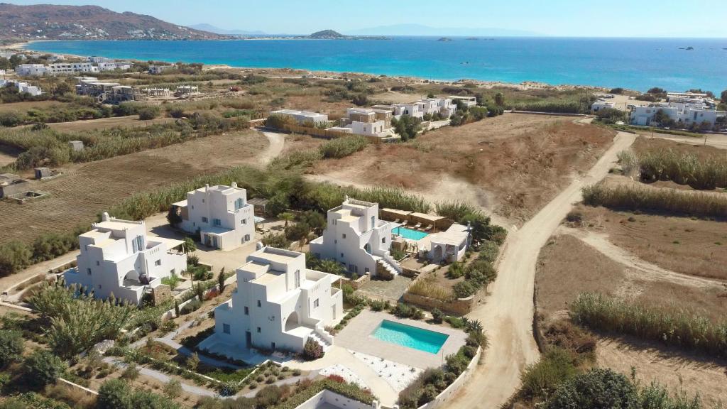 an aerial view of a white villa with the ocean at Seaside Naxos • Holiday Villas in Plaka