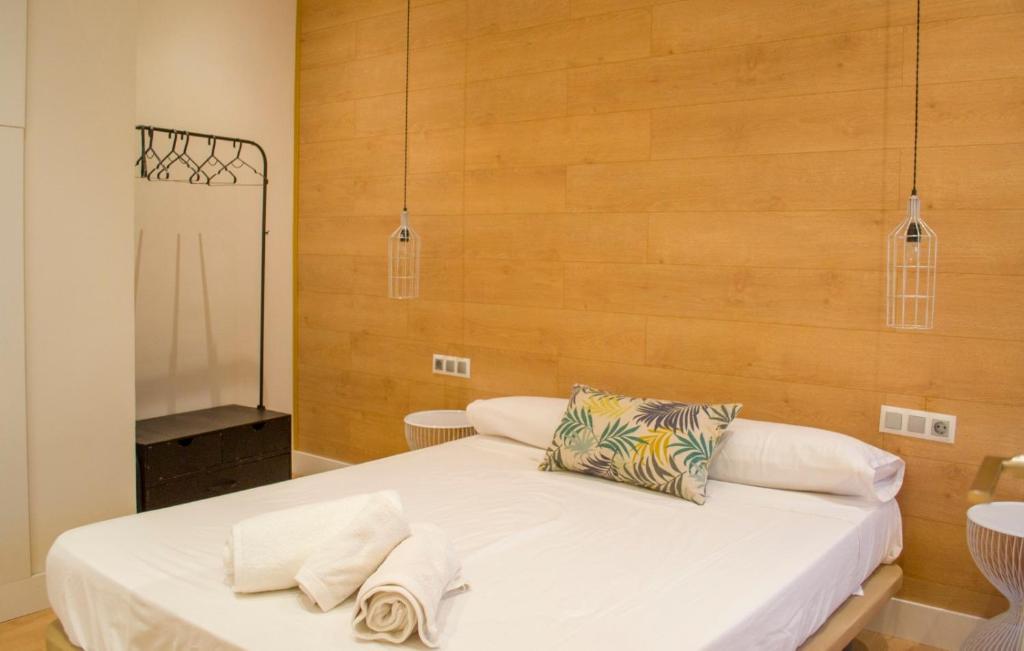 a bedroom with a bed with two towels on it at Lovely Apartament in Málaga