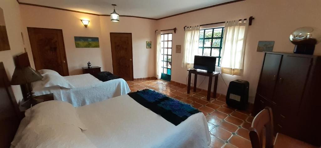 Postel nebo postele na pokoji v ubytování Casa Frida B&B