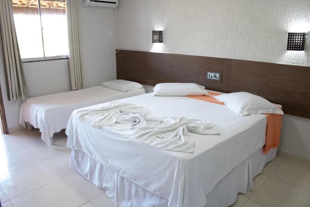Postel nebo postele na pokoji v ubytování Hotel Amendoeiras