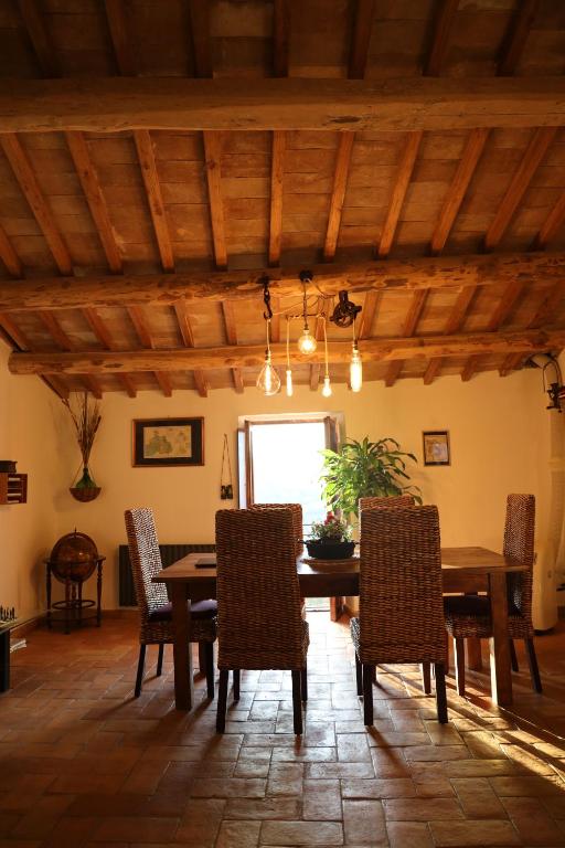 jadalnia z drewnianym stołem i krzesłami w obiekcie Dimora Turistica de' Piazza w mieście Roccalvecce