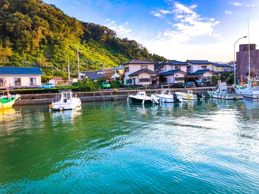 a group of boats are docked in a harbor at Ocean Lovers Home in Miyazaki