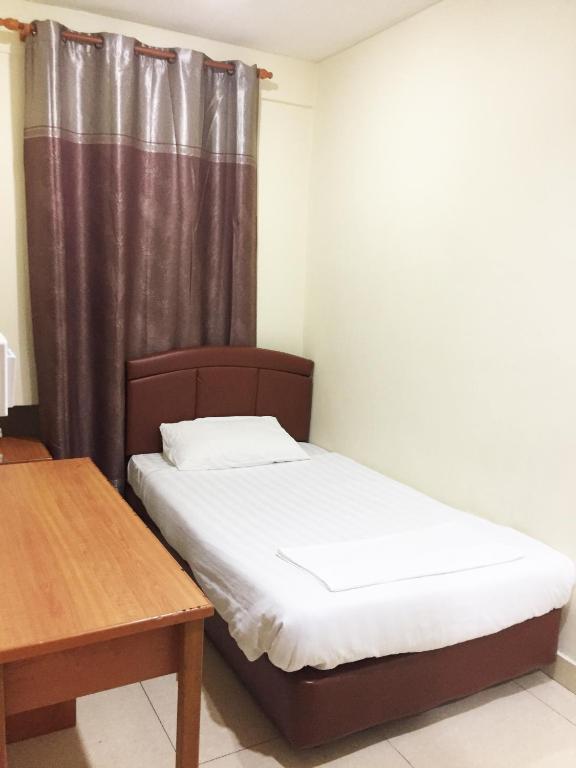 Postel nebo postele na pokoji v ubytování HK Inn Hua Kiew Inn