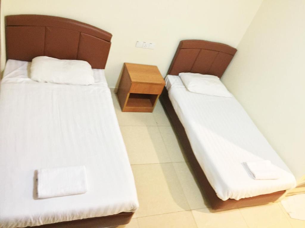 Postel nebo postele na pokoji v ubytování HK Inn Hua Kiew Inn