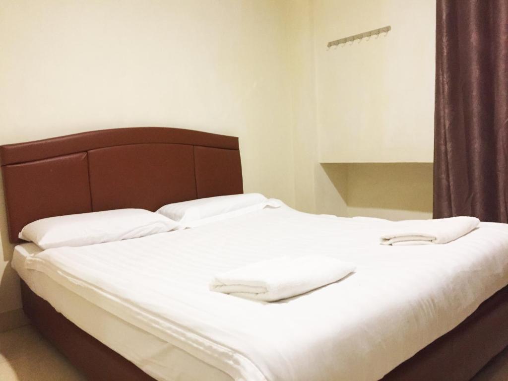 Postel nebo postele na pokoji v ubytování HK Inn Hua Kiew Inn