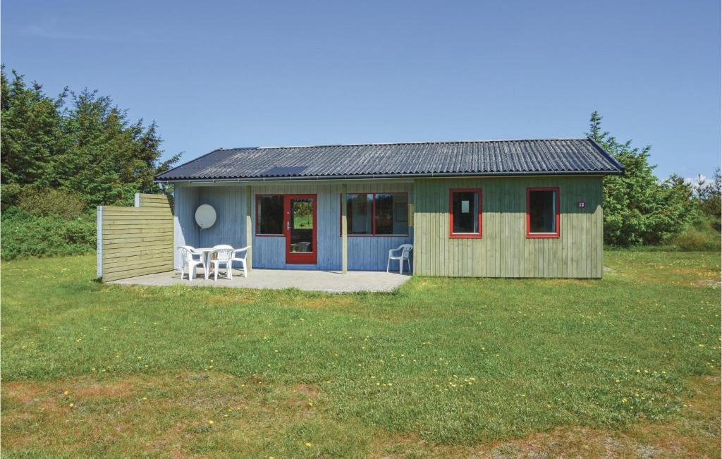KlegodにあるStunning Home In Ringkbing With 3 Bedroomsの赤い窓とデッキが備わる小さな家