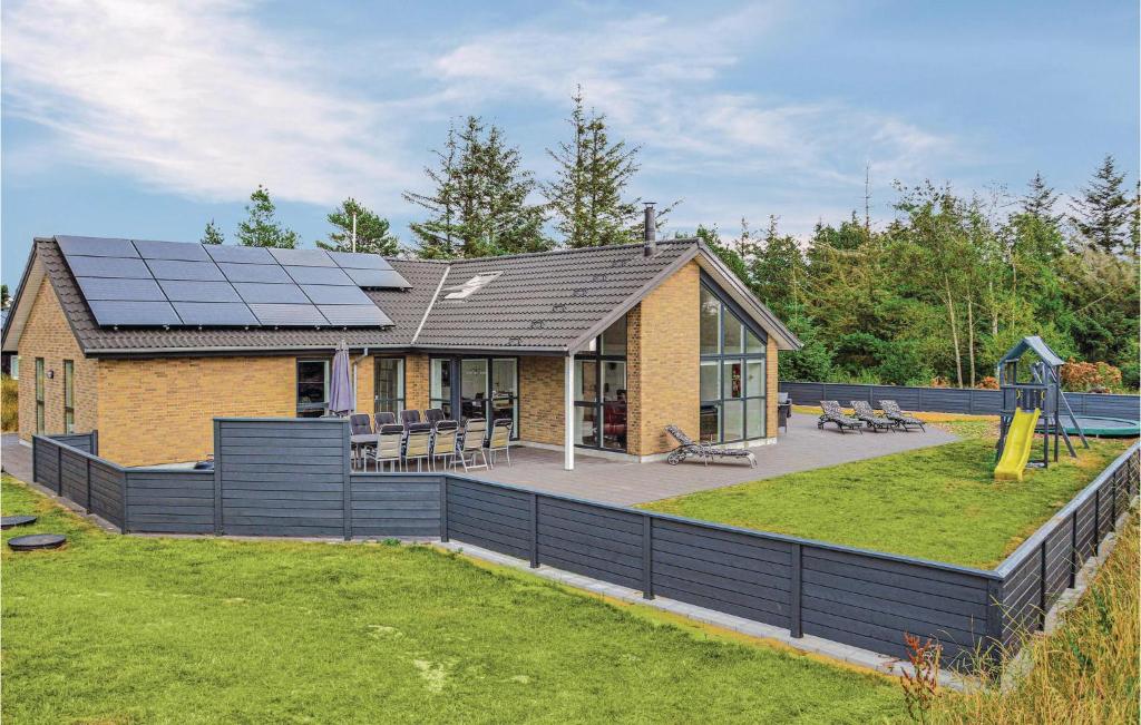 a house with solar panels on the roof at Holiday Home Fyrvej Blåvand Iv in Blåvand
