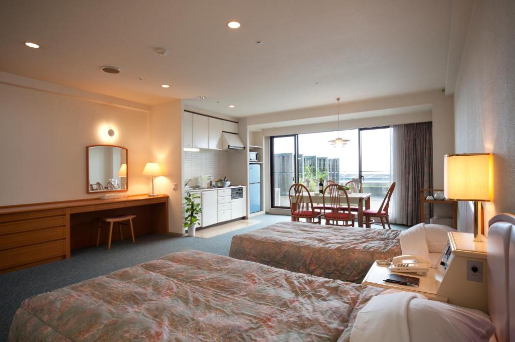 Postel nebo postele na pokoji v ubytování Izumigo AMBIENT Izu-Kogen Condominium