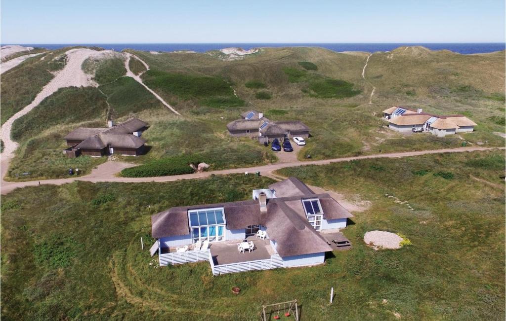 an overhead view of a house on a hill next to the ocean at Lovely Home In Hvide Sande With Kitchen in Havrvig