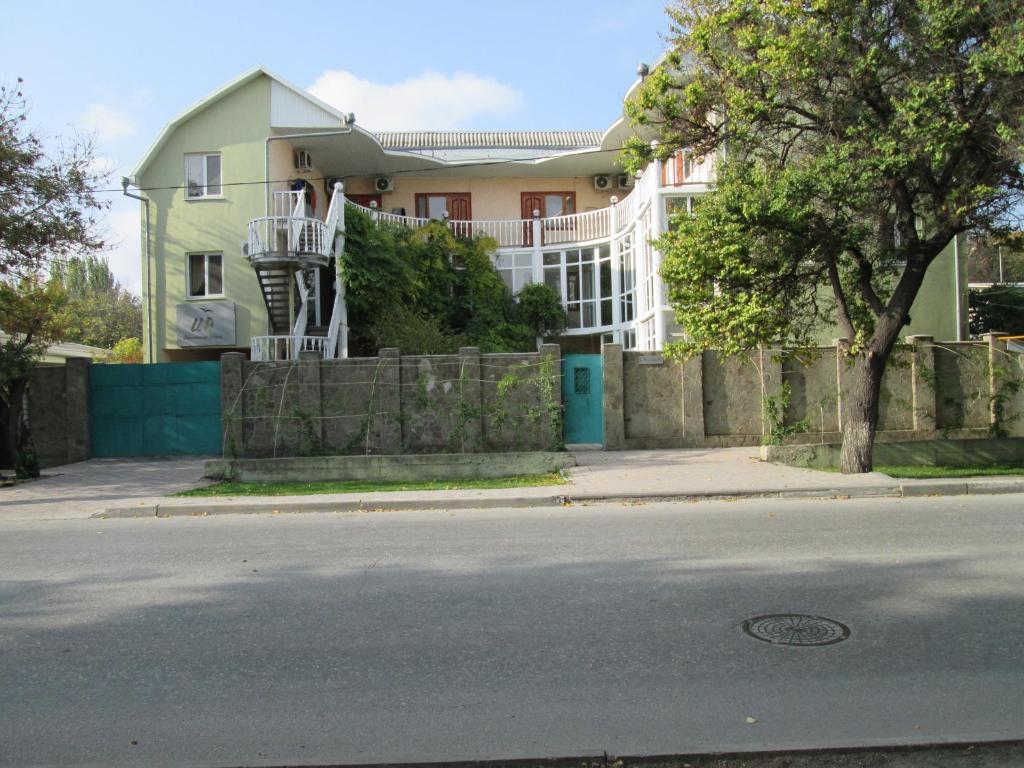 a house on the side of a street with a fence at Italian Courtyard in Feodosiya