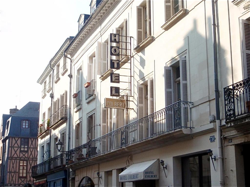 a building with balconies on the side of a street at Hotel Colbert in Tours