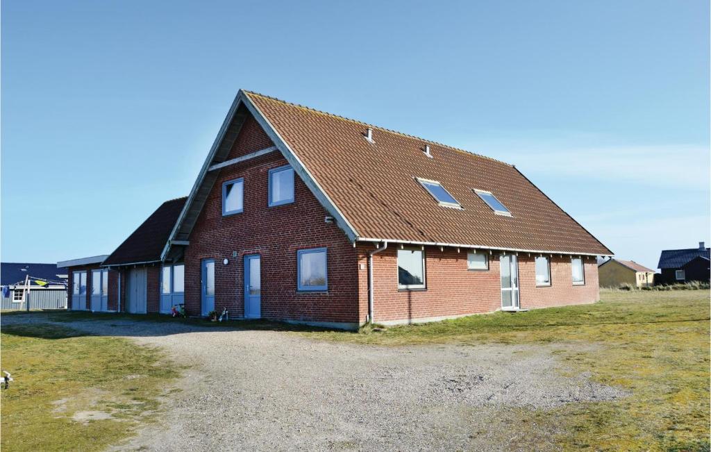 a large brick house with a brown roof at Vejlgaard in Nørre Lyngvig