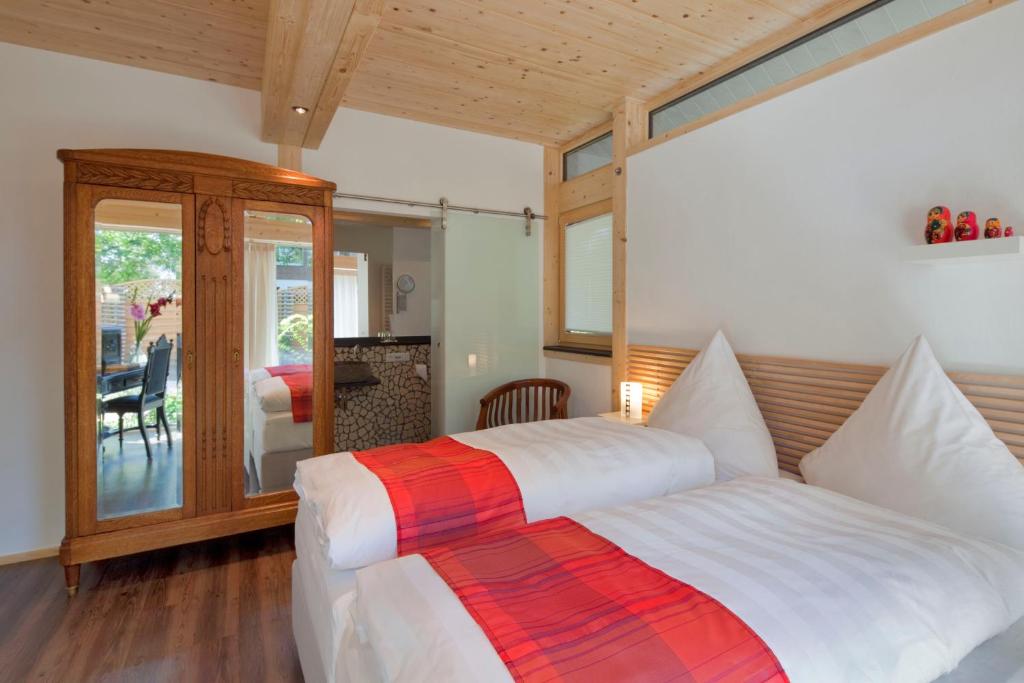 a bedroom with a large bed with white sheets at Vivere Ad Parcum - Bed And Breakfast in Krefeld