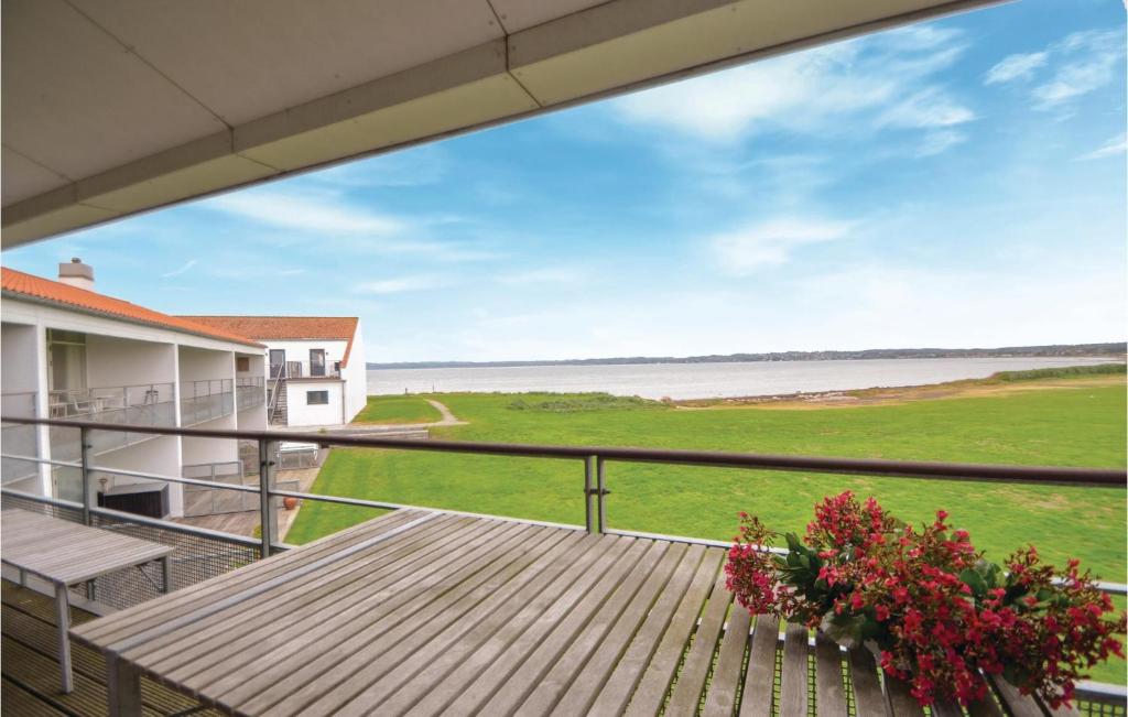 a balcony with a table and a view of the ocean at Beautiful Apartment In Ebeltoft With 2 Bedrooms, Sauna And Wifi in Ebeltoft