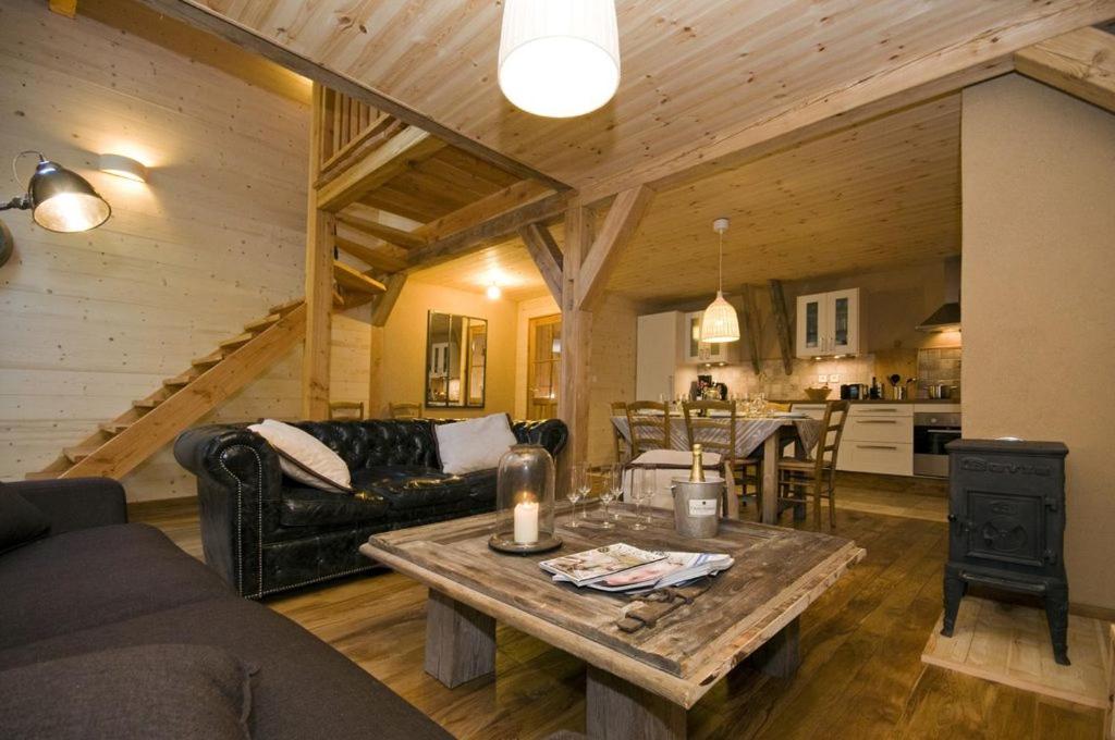 a living room with a couch and a table at Chalet Le Villarais in Villard-Reculas