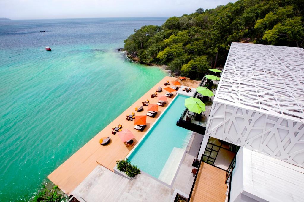 an overhead view of a swimming pool with chairs and umbrellas at Villa 360 in Phi Phi Islands