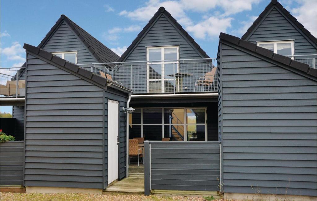 a house with black siding at Hus R in Henne Strand