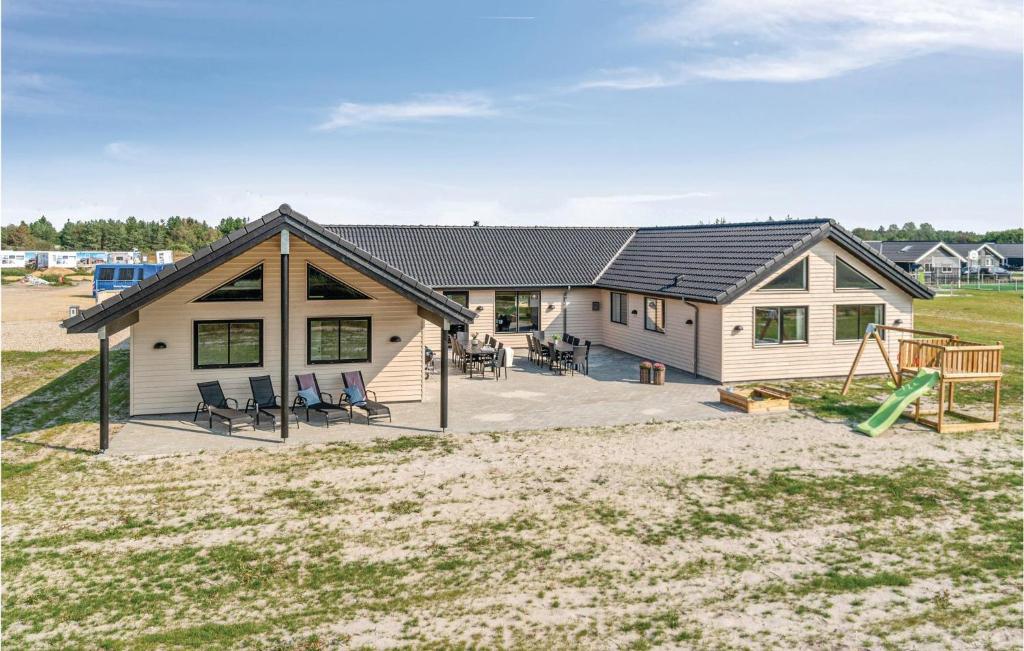 a house with a playground in front of it at Lovely Home In Nørre Nebel With Wifi in Nørre Nebel