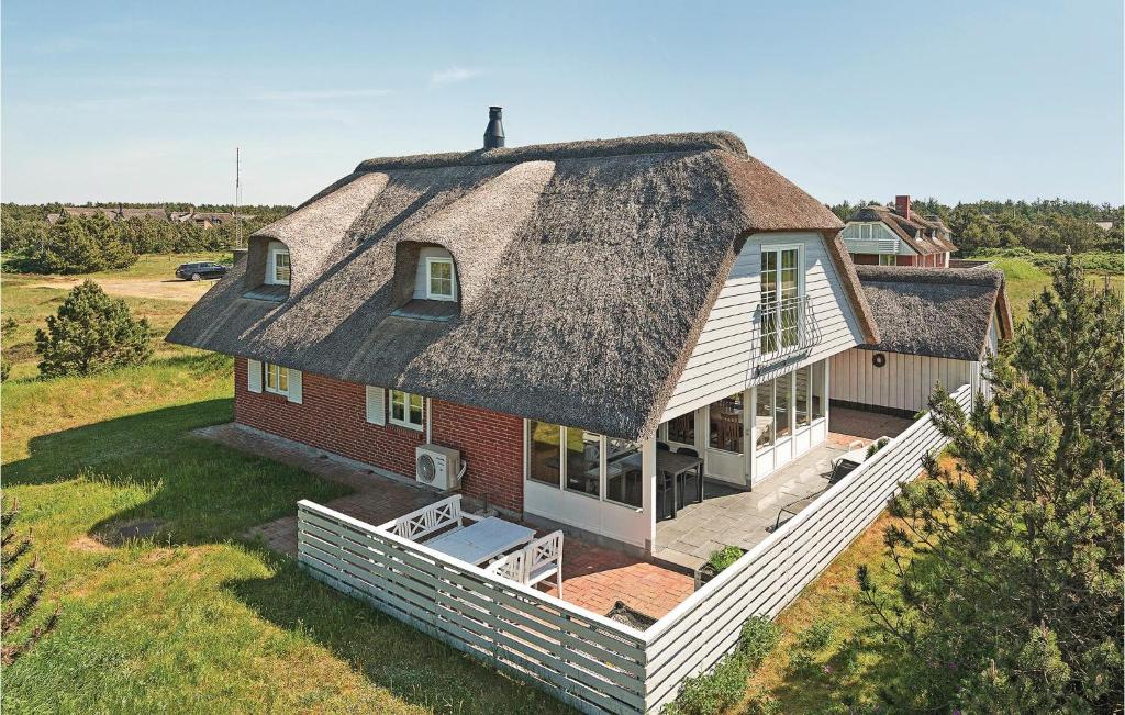 an aerial view of a house with a thatched roof at Beautiful Home In Blåvand With Sauna in Blåvand
