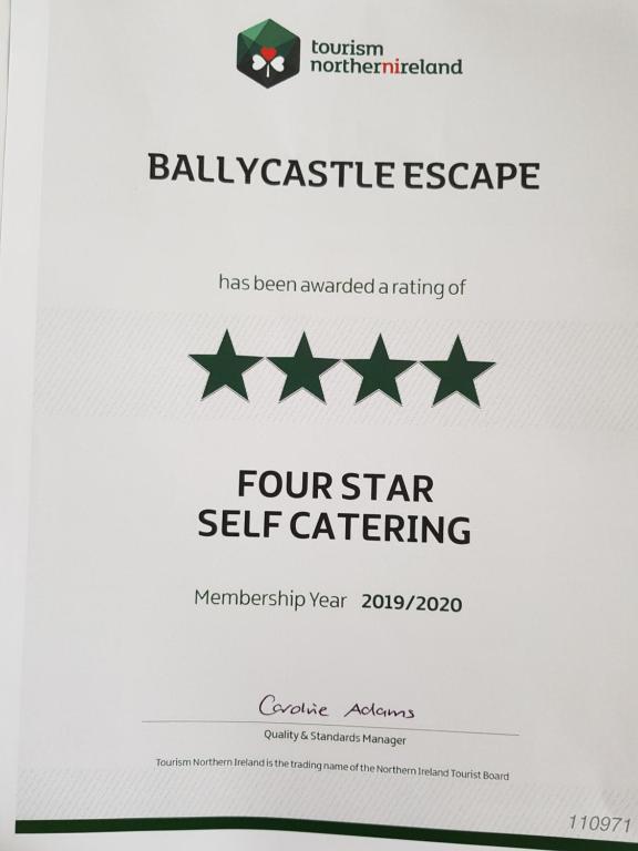 um envelope branco com certificados de dispersão de quatro estrelas em Beach View Ballycastle Escape em Ballycastle