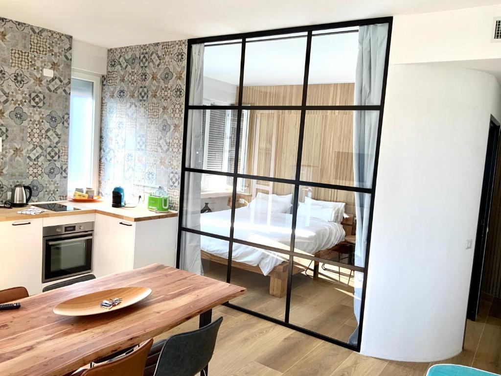 a room with a dining table and a bedroom at Luxury Flat by Central Station / Unique View in Milan