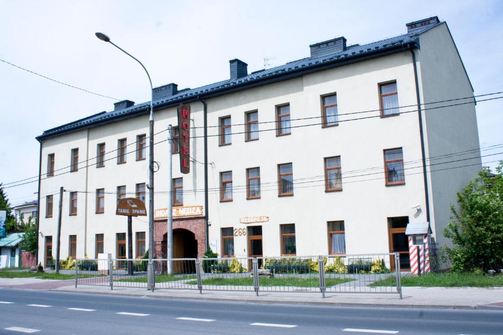 un edificio blanco al lado de una calle en Hotel Bida z Nędzą, en Ożarów Mazowiecki