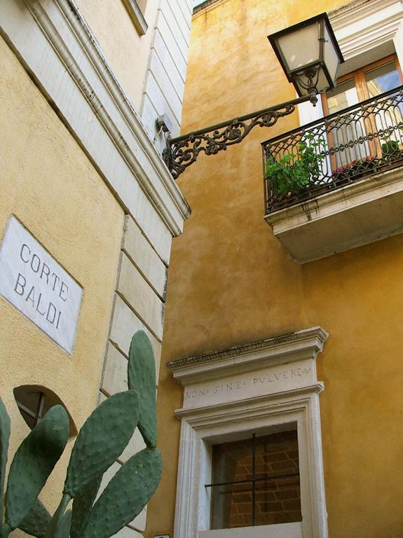 a building with a window and a sign on it at Corte Baldi in Galatina