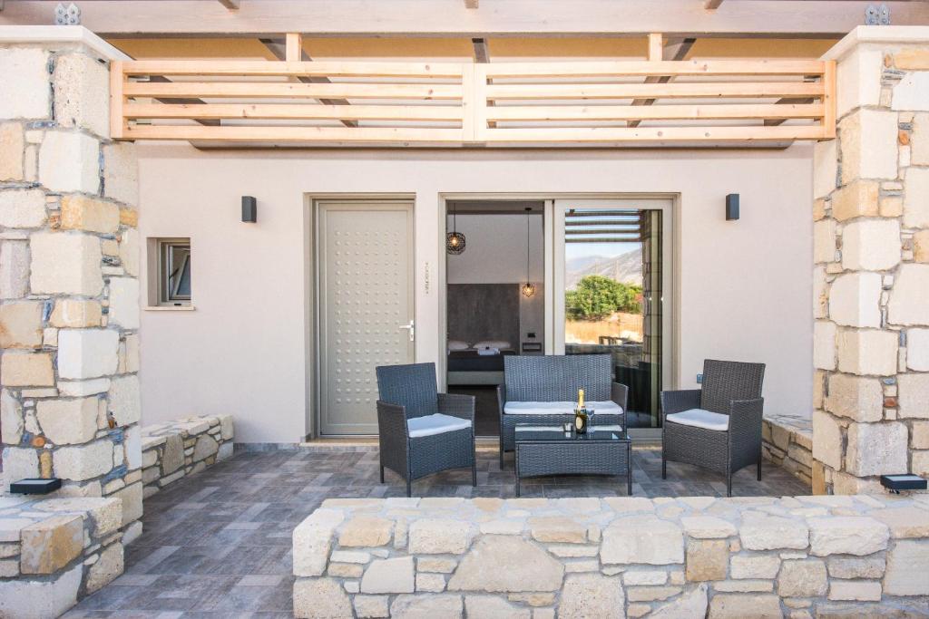 a patio with chairs and a table at Xasteria in Elafonisi