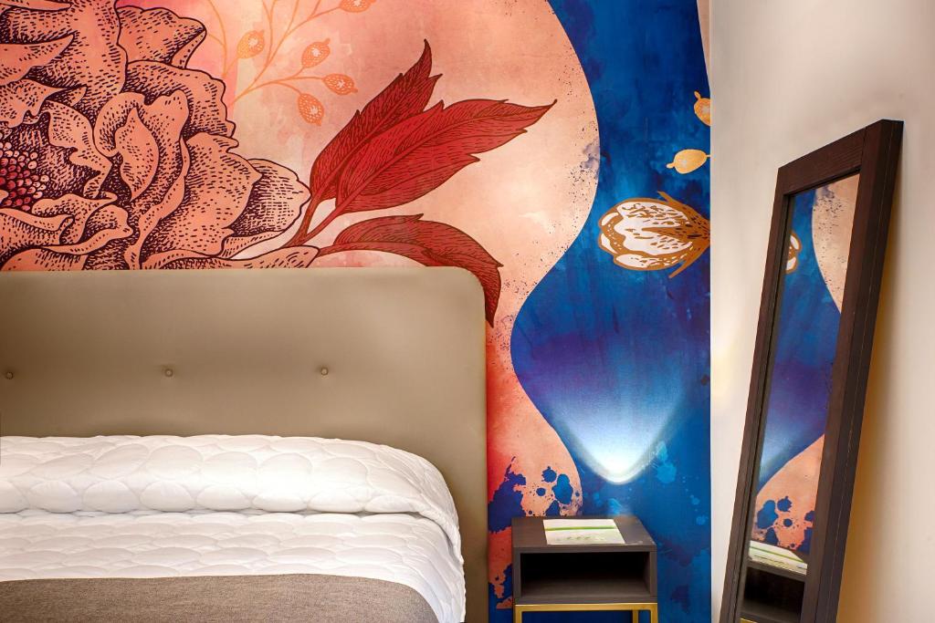 ein Schlafzimmer mit einem Bett und einem Wandgemälde in der Unterkunft B&B Napoli Time in Neapel