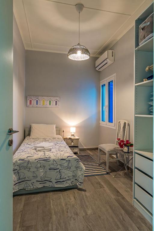 A bed or beds in a room at Villa Myrina with Sea View BY APOKORONAS-VILLAS