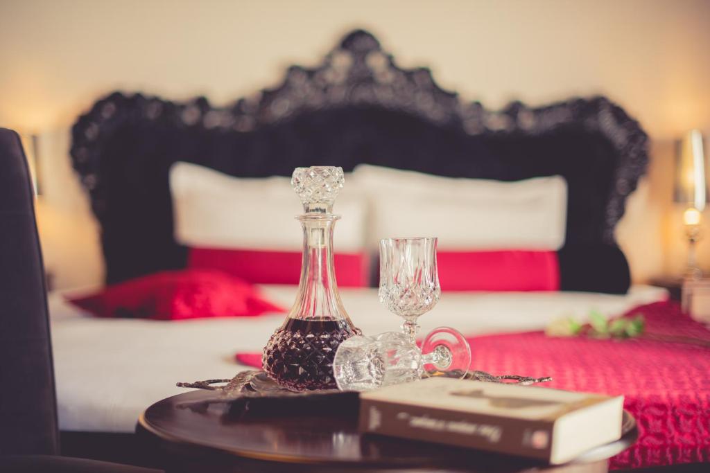 a table with two glasses and a book on a bed at Paroraia in Angistron
