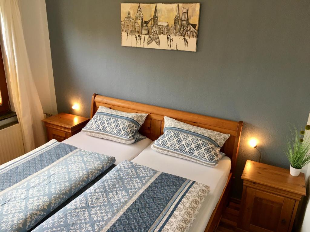 2 camas en un dormitorio pequeño con 2 lámparas en Ferienwohnung Berta Lüneburg, en Lüneburg
