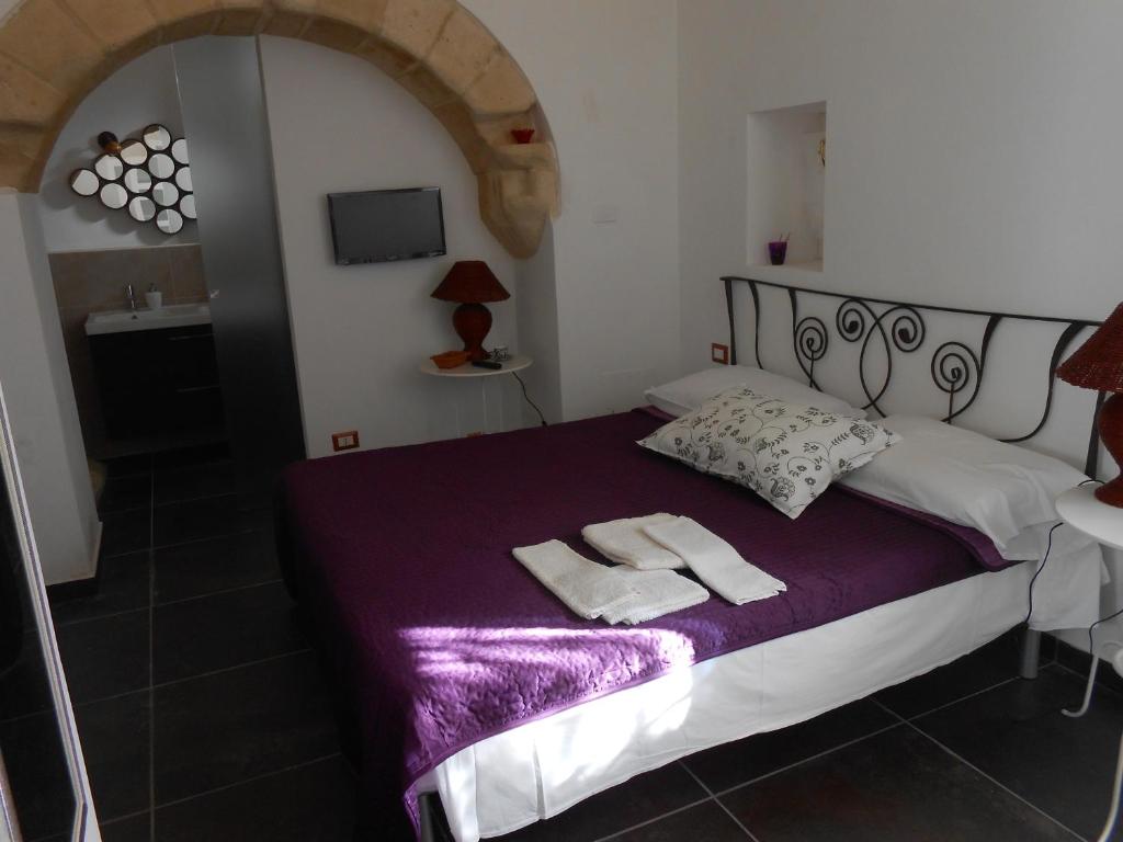 a bedroom with a bed with two towels on it at Matera's B&B in Matera
