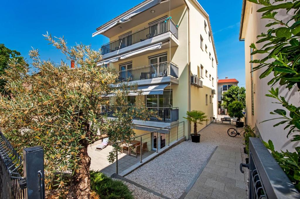 an apartment building with balconies on a street at Apartments AnaMar in Rovinj