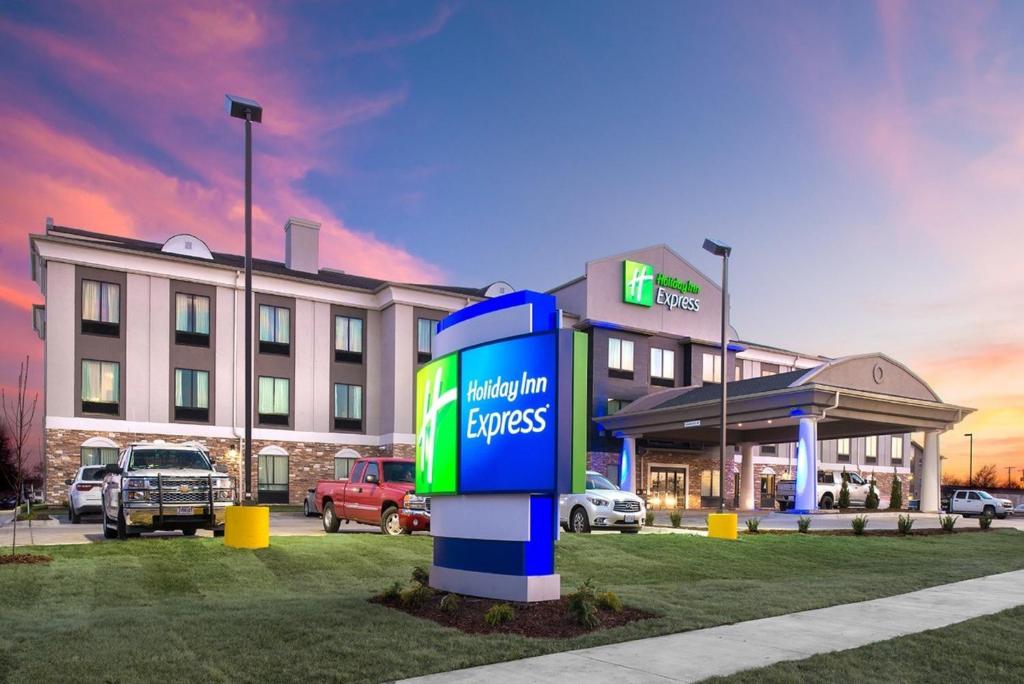 a hotel with a gas pump in front of a building at Holiday Inn Express Hutchison by IHG in Hutchinson
