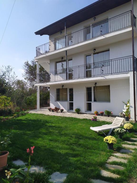a large white building with a green yard at Villa Savovi in Varna City