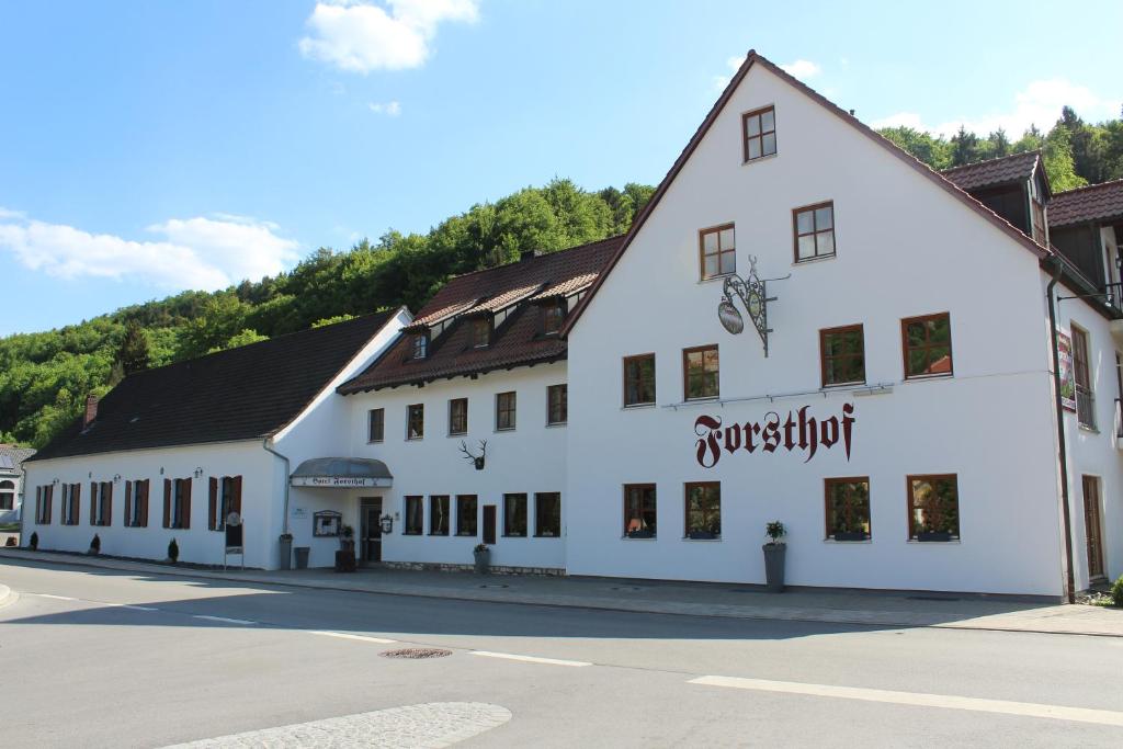 a large white building on the side of a street at Land-gut-Hotel Forsthof in Kastl