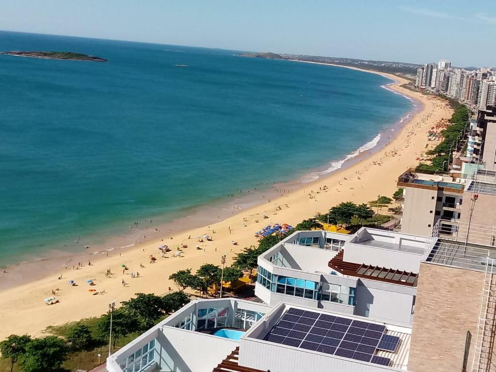 a view of a beach with people in the water at Lazer nas Alturas in Vila Velha