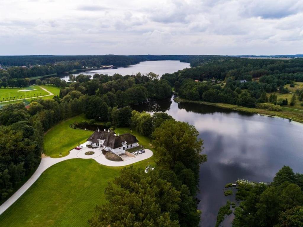 an aerial view of a large estate on a lake at Strzecha Chopina - Dom i półwysep tylko dla Ciebie in Lidzbark