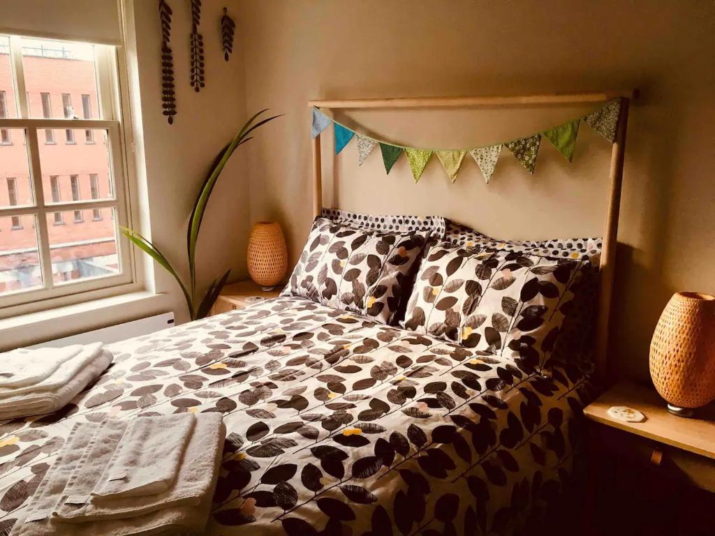 a bedroom with a bed with a cow print bedspread at Stylish City Centre Flat in Leeds