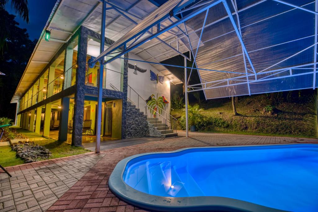 a house with a swimming pool in front of a building at Hotel Casa Conley Del Mar in Puerto Viejo