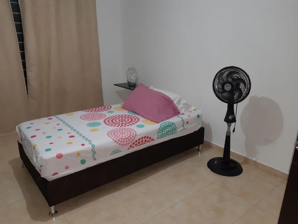 a bedroom with a bed and a fan at Estadia del Lili in Cali