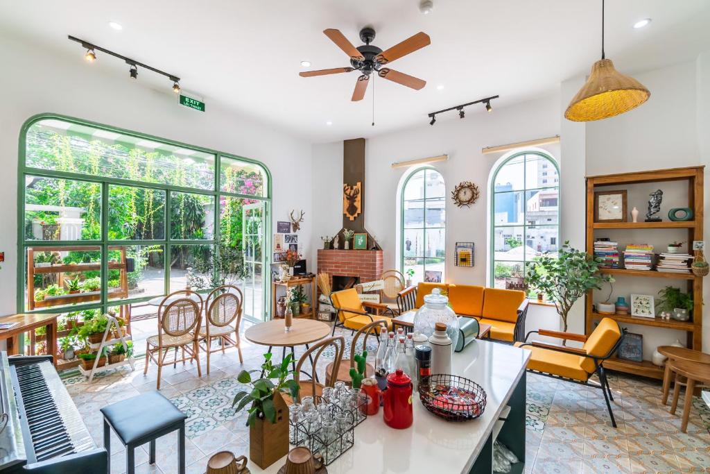 a living room with a lot of furniture and windows at NẮNG House in Da Nang