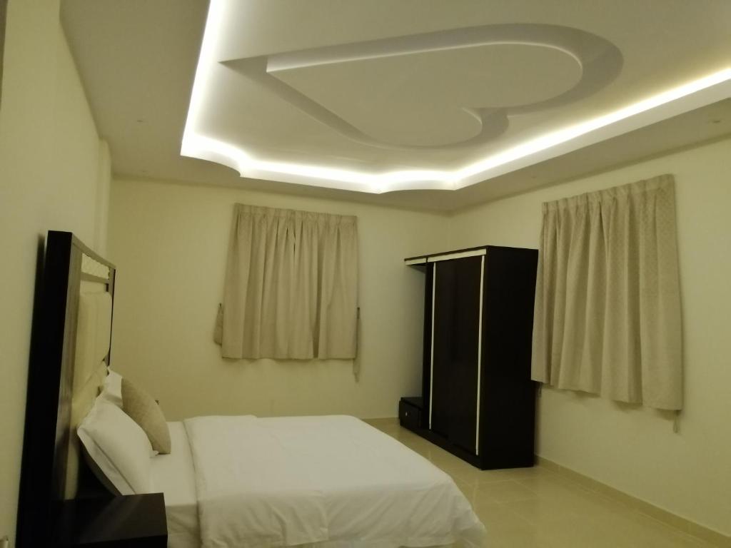 Postel nebo postele na pokoji v ubytování Fakhamat Al Orjoana & Suites