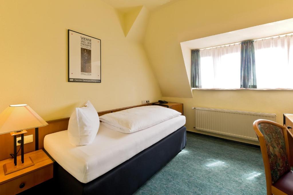 Postel nebo postele na pokoji v ubytování Hotel Katharinenhof