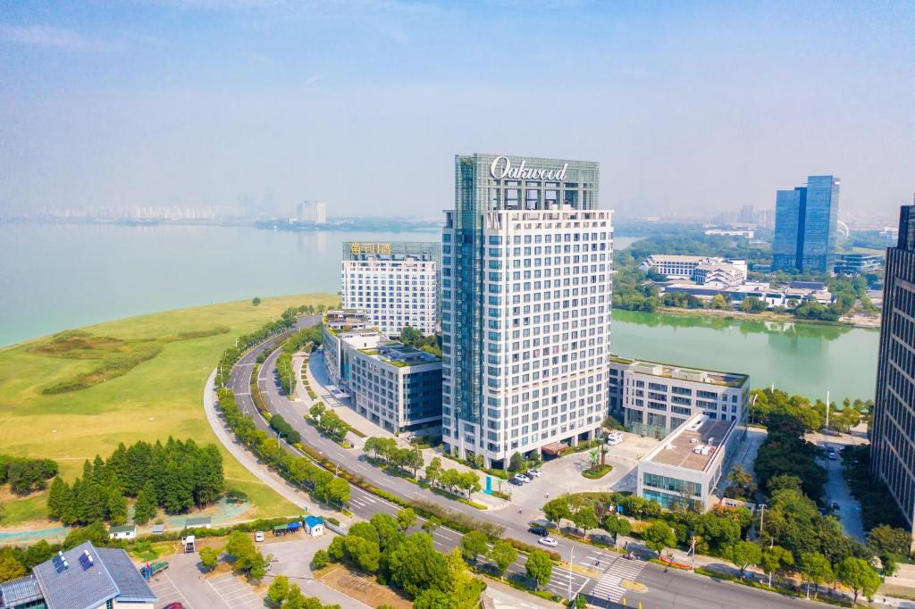 an aerial view of a tall building next to a river at Oakwood Hotel & Residence Suzhou in Suzhou