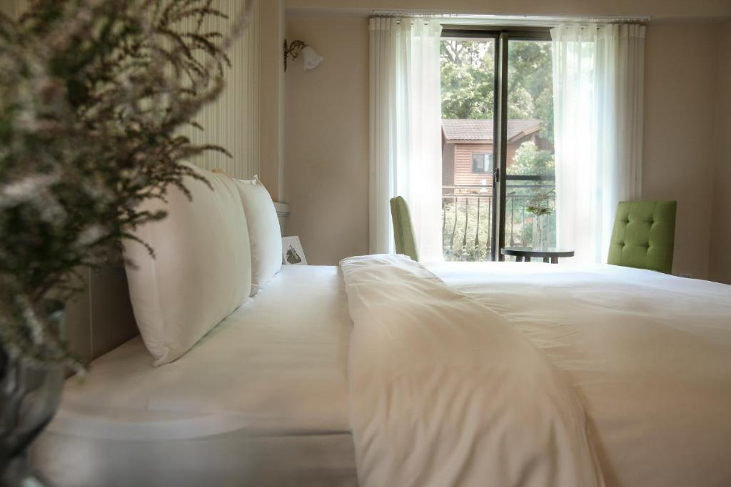 Postel nebo postele na pokoji v ubytování Yo Shen Jing Resorts