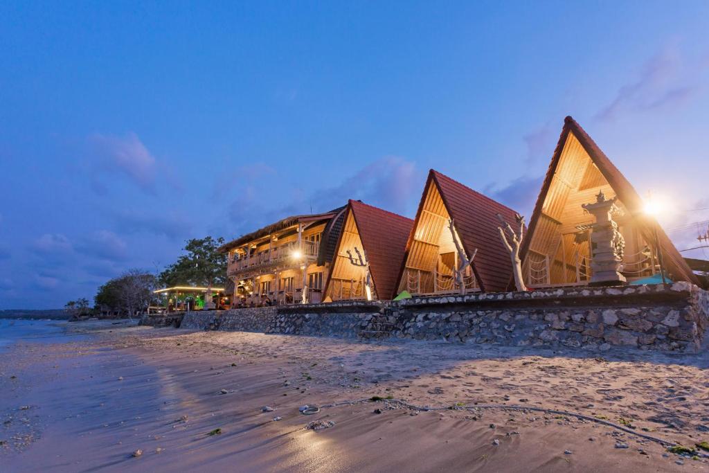 a building on the beach at night at The Dewi Sun Sun Nusa Penida in Nusa Penida